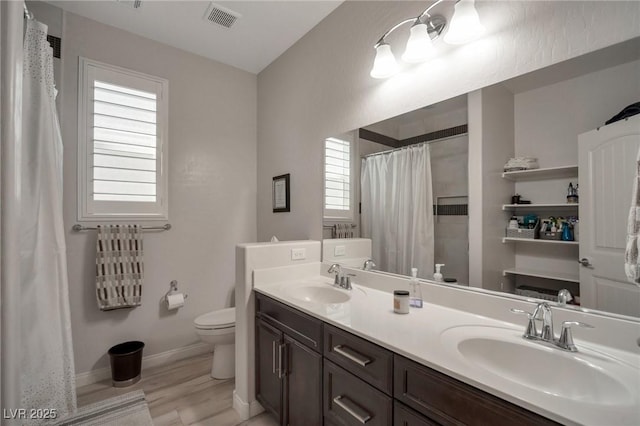 205 Piedmont Alps St, Henderson, NV 89012 - full bath with toilet, double vanity, a shower with shower curtain, wood finished floors, and baseboards