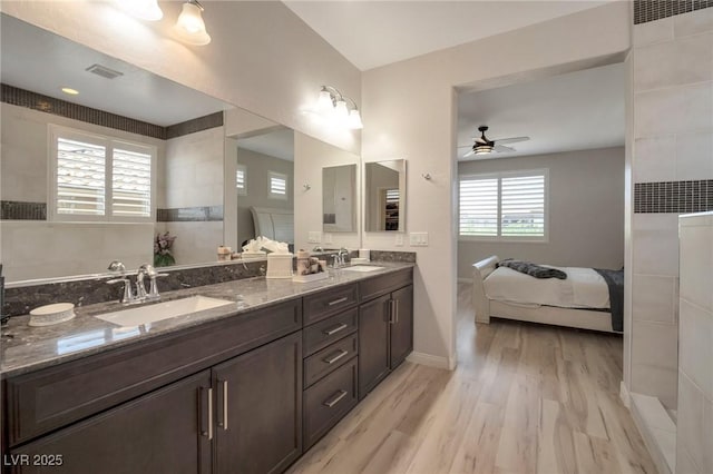 205 Piedmont Alps St, Henderson, NV 89012 - ensuite bathroom featuring a ceiling fan, wood finished floors, double vanity, and baseboards