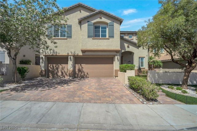 205 Piedmont Alps St, Henderson, NV 89012 - mediterranean / spanish house with stucco siding, a garage, and decorative driveway