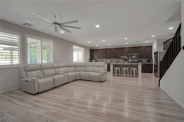 205 Piedmont Alps St, Henderson, NV 89012 - living room featuring a ceiling fan, recessed lighting, light wood-style floors, and stairs