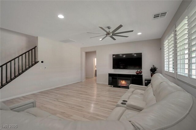 205 Piedmont Alps St, Henderson, NV 89012 - living area with ceiling fan, light wood-type flooring, stairway, recessed lighting, and a glass covered fireplace