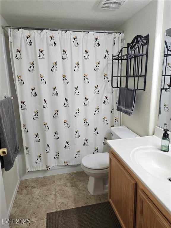 bathroom featuring toilet, shower / tub combo with curtain, vanity, tile patterned flooring, and baseboards