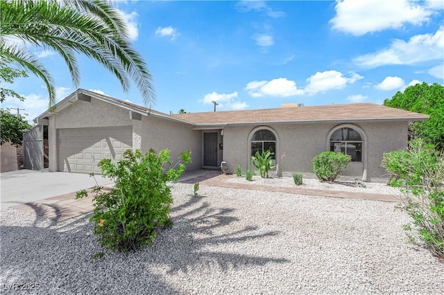 ranch-style house featuring stucco siding, concrete driveway, and a garage
