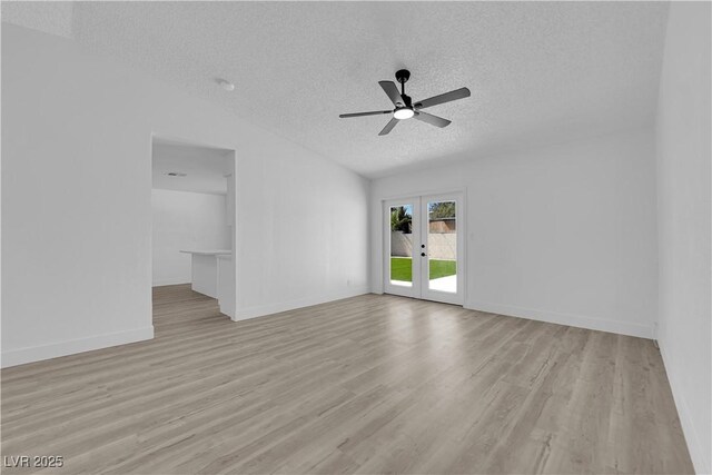 unfurnished living room featuring a textured ceiling, french doors, light wood-style flooring, a ceiling fan, and baseboards