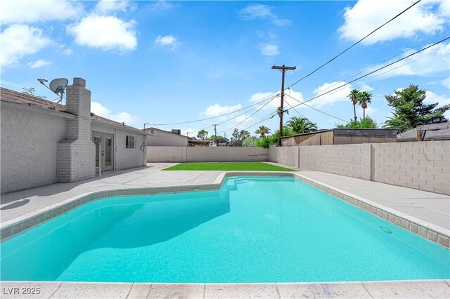 view of swimming pool with a fenced backyard and a patio area