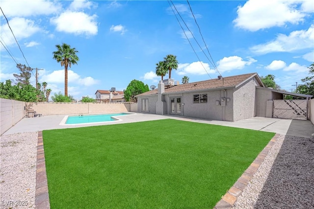 view of yard featuring a patio and french doors