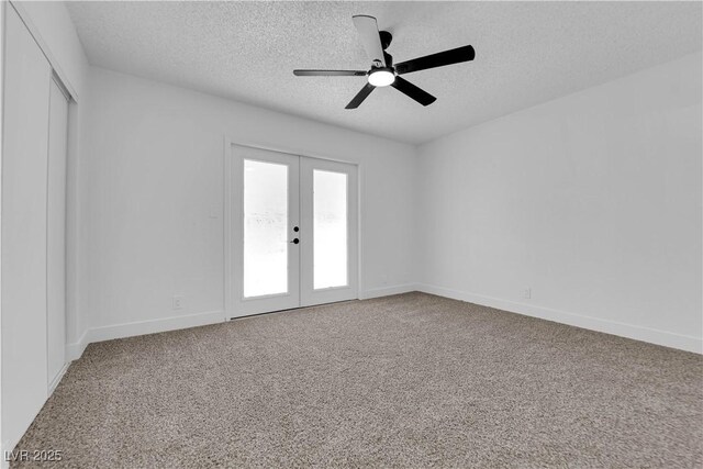 carpeted empty room featuring french doors, a textured ceiling, ceiling fan, and baseboards
