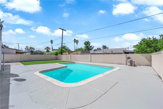 view of swimming pool with a patio and a fenced backyard