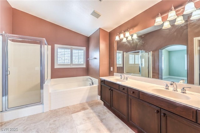 full bathroom with lofted ceiling, a bath, a shower stall, and double vanity