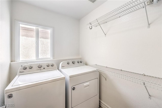 washroom with washing machine and clothes dryer