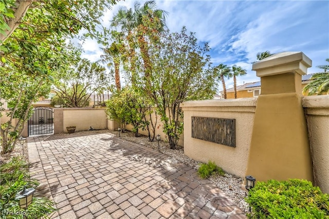 view of patio with a gate