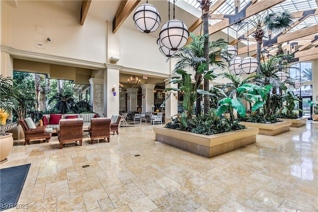 lobby with a high ceiling and beamed ceiling