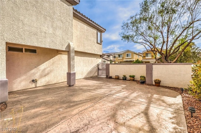 view of patio featuring a gate and fence