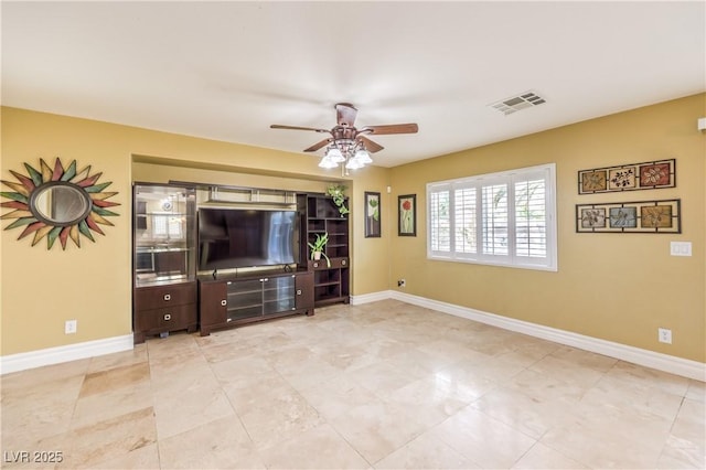 unfurnished living room with a ceiling fan and baseboards