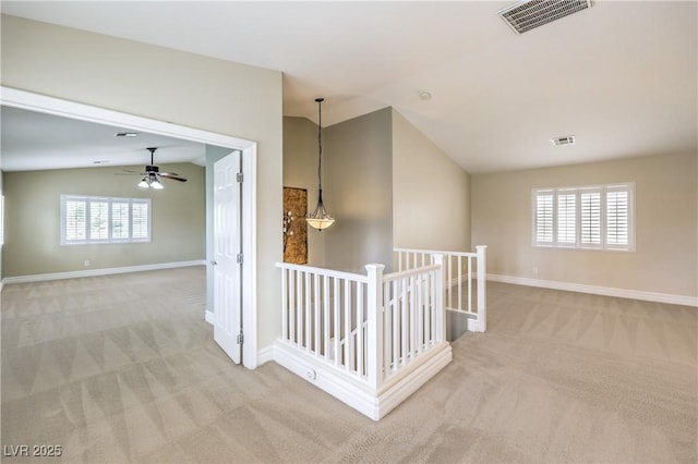 hallway with vaulted ceiling, carpet flooring, an upstairs landing, and baseboards