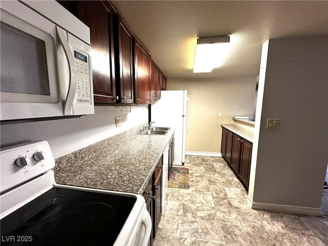 5188 River Glen Dr Unit 453, Las Vegas, NV 89103 - kitchen featuring white appliances, baseboards, dark brown cabinetry, stone finish floors, and a textured ceiling