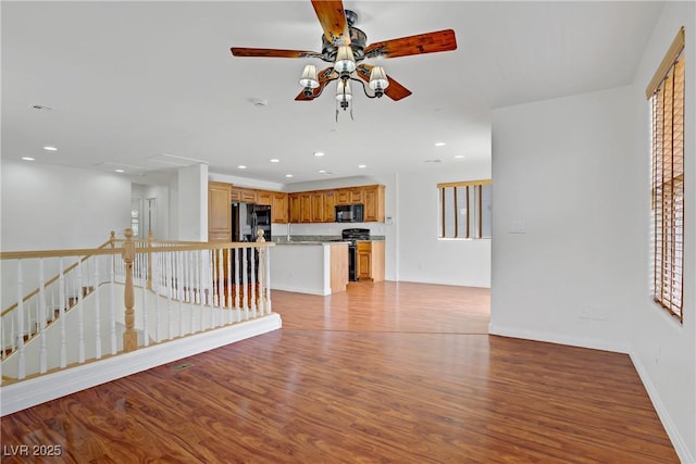 11247 Villa Trentino Ct, Las Vegas, NV 89141 - unfurnished living room with light wood-style floors, ceiling fan, recessed lighting, and baseboards