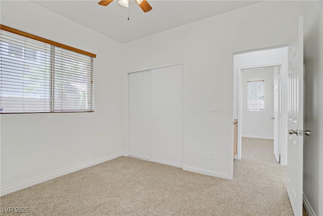 11247 Villa Trentino Ct, Las Vegas, NV 89141 - unfurnished bedroom with carpet flooring, a closet, baseboards, and a ceiling fan