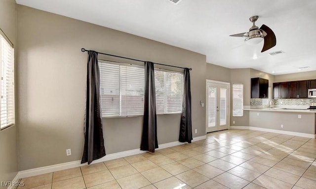 971 Whispering Grove Ave, Las Vegas, NV 89123 - unfurnished living room featuring healthy amount of natural light, a ceiling fan, light tile patterned floors, and french doors