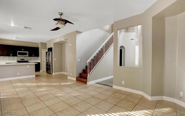 971 Whispering Grove Ave, Las Vegas, NV 89123 - unfurnished living room featuring light tile patterned floors, a ceiling fan, stairs, and baseboards