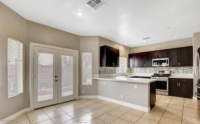 971 Whispering Grove Ave, Las Vegas, NV 89123 - kitchen featuring stainless steel appliances, french doors, light tile patterned floors, and recessed lighting