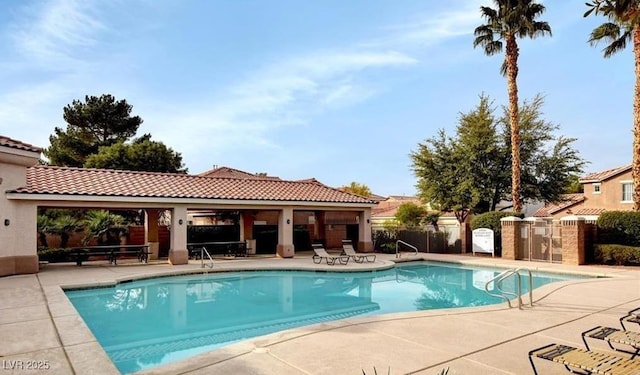 971 Whispering Grove Ave, Las Vegas, NV 89123 - community pool with a patio area and fence