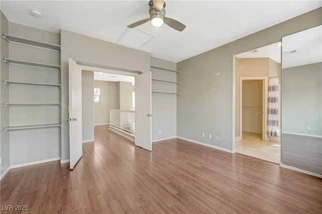 971 Whispering Grove Ave, Las Vegas, NV 89123 - unfurnished bedroom featuring wood finished floors, a closet, ceiling fan, and a spacious closet