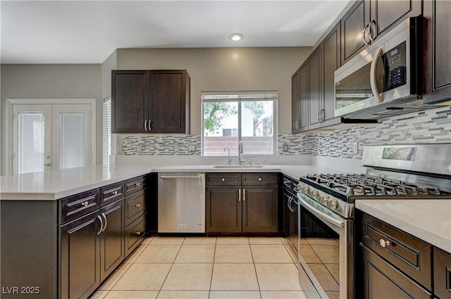 971 Whispering Grove Ave, Las Vegas, NV 89123 - kitchen featuring appliances with stainless steel finishes, a peninsula, light countertops, decorative backsplash, and recessed lighting