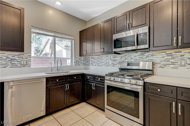 971 Whispering Grove Ave, Las Vegas, NV 89123 - kitchen featuring stainless steel appliances, light countertops, light tile patterned flooring, and tasteful backsplash