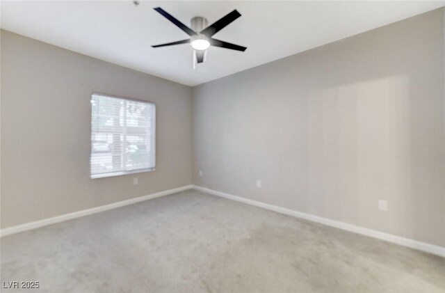 empty room featuring light carpet, baseboards, and a ceiling fan
