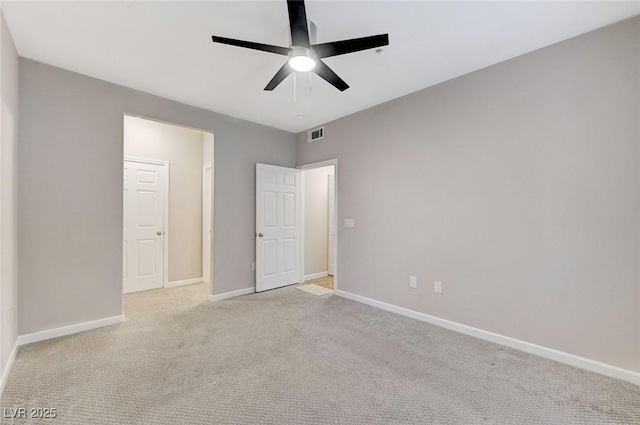 unfurnished bedroom featuring carpet, baseboards, and a ceiling fan