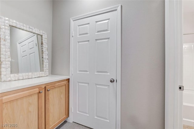 full bath with a tub to relax in and vanity