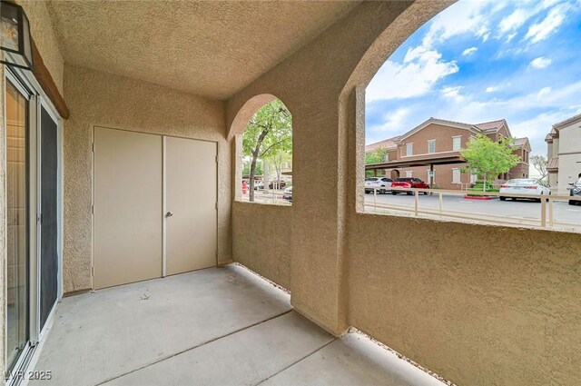 view of patio with a balcony and a residential view
