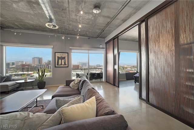 900 Las Vegas Blvd Unit 715, Las Vegas, NV 89101 - living room featuring track lighting, a city view, finished concrete floors, and baseboards