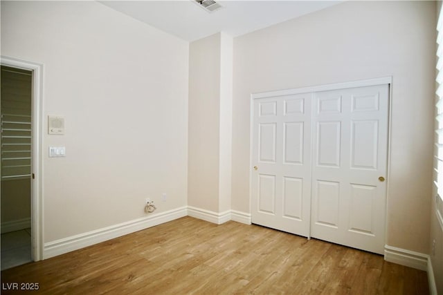 66 Sunset Bay St, Las Vegas, NV 89148 - unfurnished bedroom with light wood-style floors, baseboards, and a closet