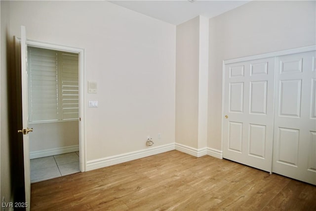 66 Sunset Bay St, Las Vegas, NV 89148 - unfurnished bedroom featuring wood finished floors, baseboards, and a closet
