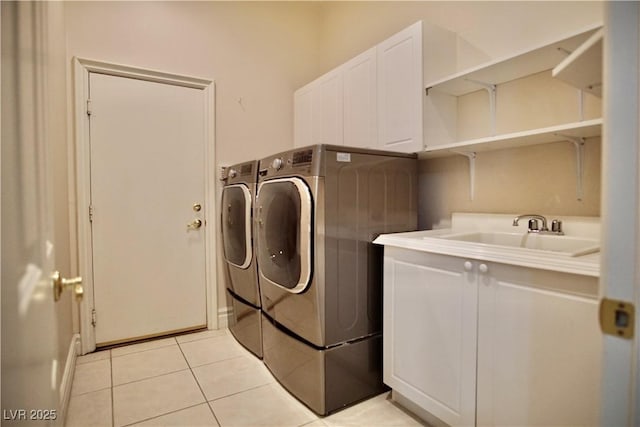66 Sunset Bay St, Las Vegas, NV 89148 - laundry area featuring washing machine and dryer, cabinet space, and light tile patterned floors