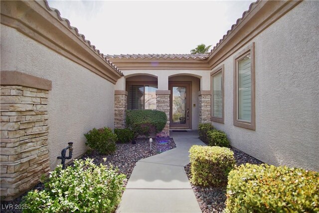 66 Sunset Bay St, Las Vegas, NV 89148 - property entrance featuring stucco siding, stone siding, and a tile roof