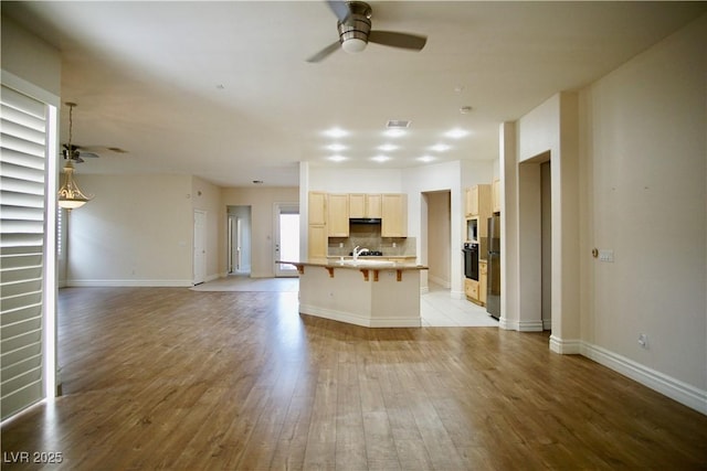 66 Sunset Bay St, Las Vegas, NV 89148 - unfurnished living room featuring ceiling fan, a sink, light wood-style flooring, and baseboards