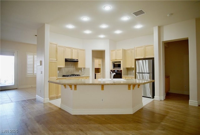 66 Sunset Bay St, Las Vegas, NV 89148 - kitchen with appliances with stainless steel finishes, light wood-type flooring, backsplash, a sink, and recessed lighting