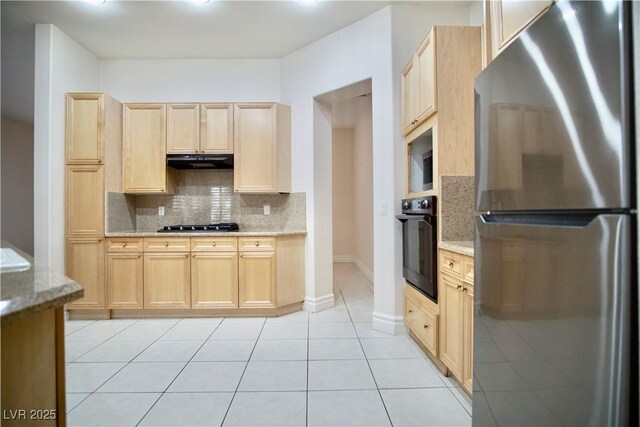 66 Sunset Bay St, Las Vegas, NV 89148 - kitchen featuring appliances with stainless steel finishes, light brown cabinets, decorative backsplash, under cabinet range hood, and light stone counters