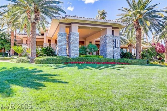 66 Sunset Bay St, Las Vegas, NV 89148 - view of front of property featuring stucco siding, stone siding, and a front lawn