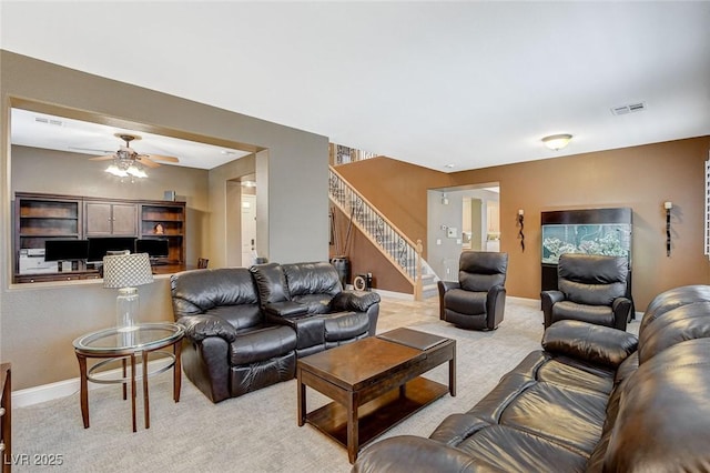 6409 Sea Swallow St, North Las Vegas, NV 89084 - living room featuring light carpet, stairway, baseboards, and ceiling fan