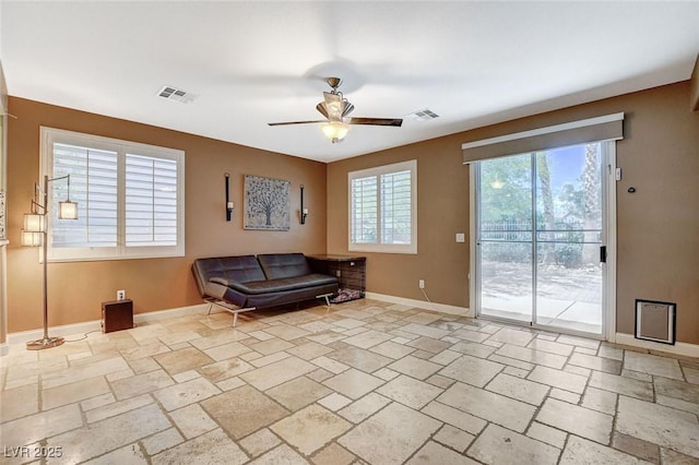 6409 Sea Swallow St, North Las Vegas, NV 89084 - sitting room with stone tile flooring, a ceiling fan, and baseboards