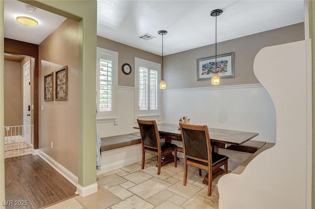 6409 Sea Swallow St, North Las Vegas, NV 89084 - dining room featuring a wainscoted wall and baseboards