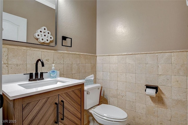 6409 Sea Swallow St, North Las Vegas, NV 89084 - half bathroom featuring toilet, vanity, and tile walls
