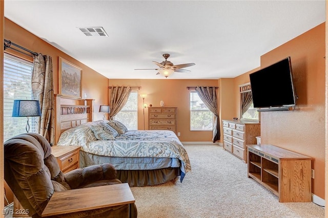 6409 Sea Swallow St, North Las Vegas, NV 89084 - bedroom with light colored carpet, baseboards, and a ceiling fan