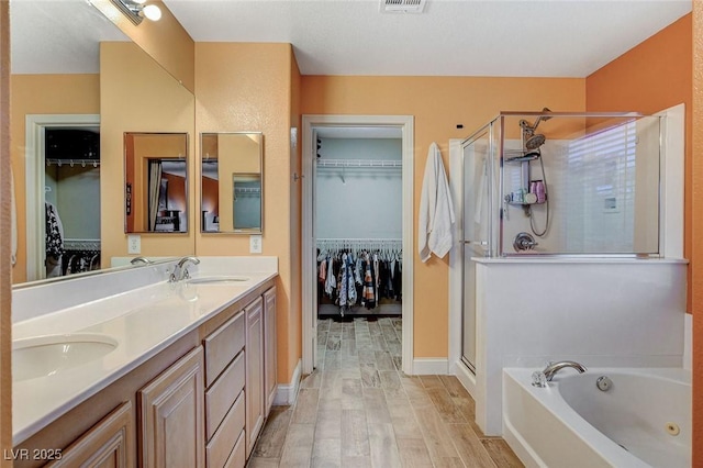 6409 Sea Swallow St, North Las Vegas, NV 89084 - bathroom with a shower stall, a garden tub, double vanity, and a walk in closet