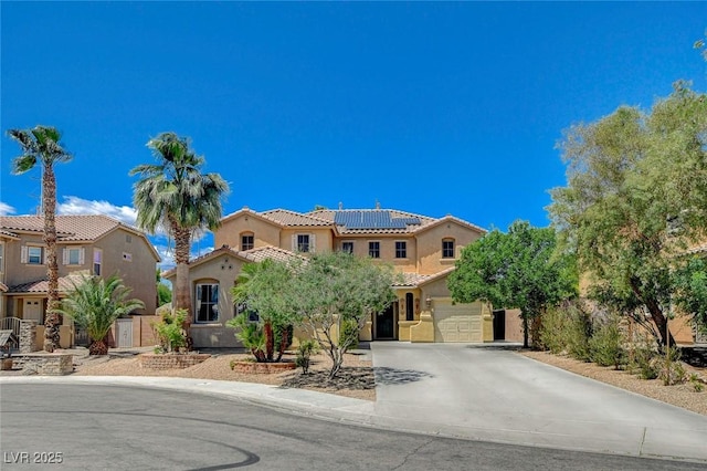 6409 Sea Swallow St, North Las Vegas, NV 89084 - mediterranean / spanish house with driveway, solar panels, stucco siding, a tiled roof, and fence