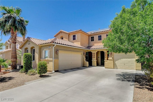 6409 Sea Swallow St, North Las Vegas, NV 89084 - mediterranean / spanish-style house with concrete driveway, a tiled roof, stucco siding, and a garage